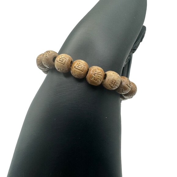 Hand-Carved Wooden Look Bead Bracelet With Intricate Symbols - Picture 4 of 5